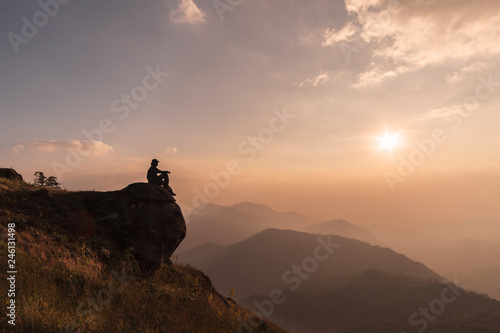 Young traveler relaxing and looking beautiful landscape on top of mountain, Adventure travel lifestyle concept