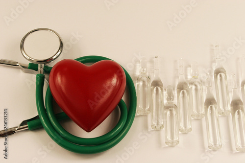 Pharmaceutical medicament, cure in container for health, stethoscope and heart on white background.