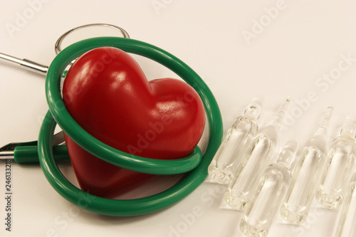 Pharmaceutical medicament, cure in container for health, stethoscope and heart on white background.