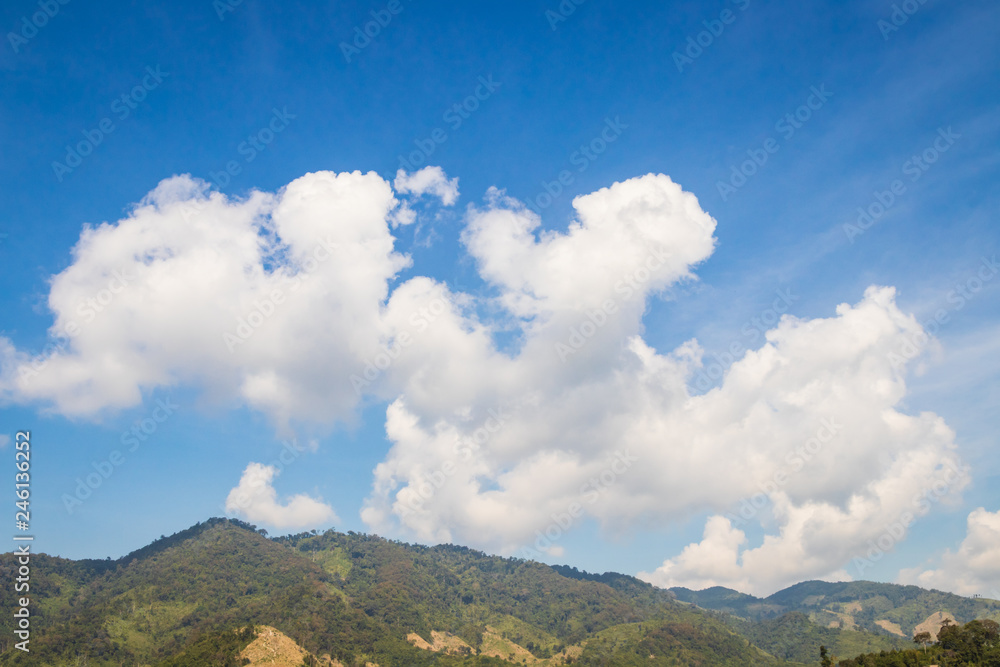 Sky with white clouds floating over mountains Sky with white clouds floating over mountains