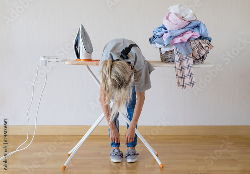 Schilderij op canvas Exhausted woman lying on ironing desk