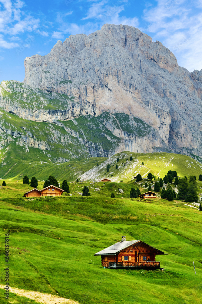 Seceda mountain with blue grass and wooden houses