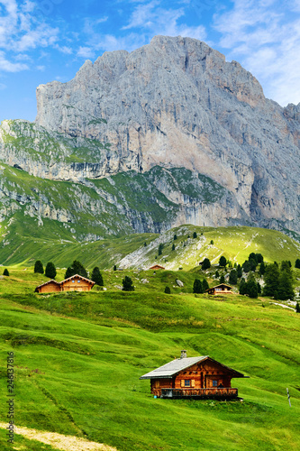 Seceda mountain with blue grass and wooden houses