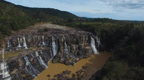 Aerial reverse tilting shot above Dalat Pongour waterfalls in Vietnam. photo