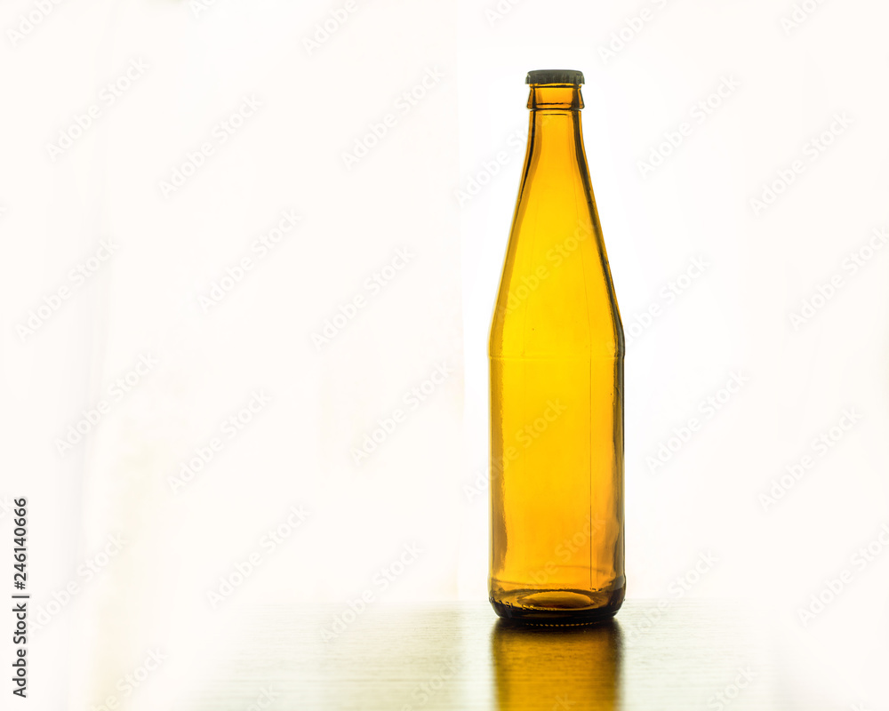 empty beer bottle on table on white background empty beer bottle on table on white background