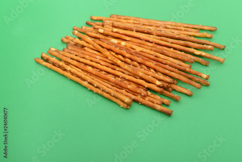 many salted sticks over a green background