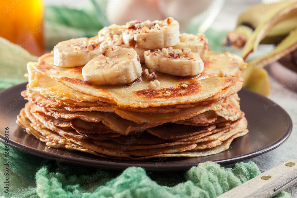 Thin pancakes with banana, walnuts and honey
