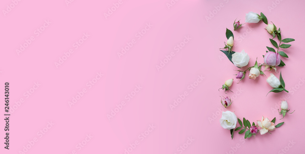 Figure 8 made of different flowers on pink background