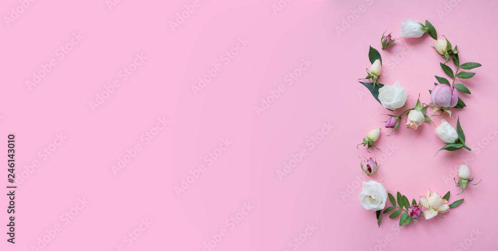 Figure 8 made of different flowers on pink background Figure 8 made of different flowers on pink background