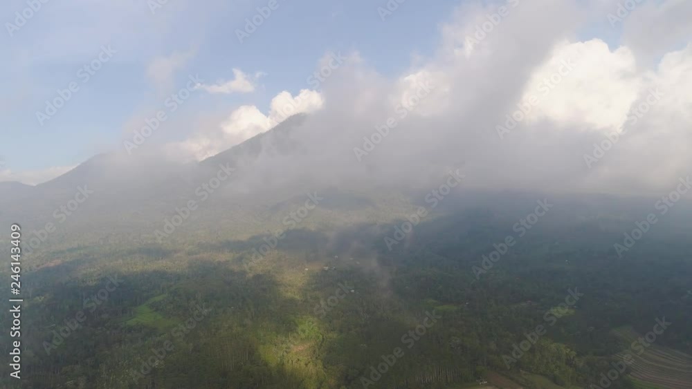 rural landscape with farmlands, rice terraces against mountains. Aerial view agricultural land on mountainside. tropical landscape Bali, Indonesia. rural landscape with farmlands, rice terraces against mountains. Aerial view agricultural land on mountainside. tropical landscape Bali, Indonesia.