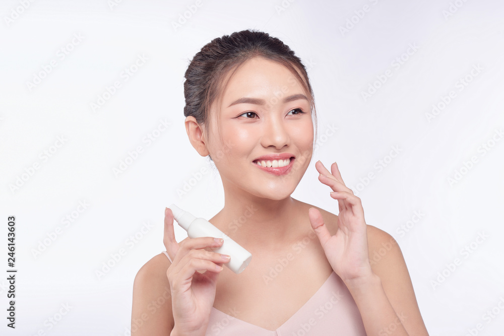 A beautiful woman holding a skin care product, moisturizer or lotion A beautiful woman holding a skin care product, moisturizer or lotion