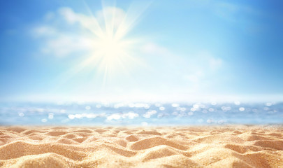 Summer background, nature of tropical golden beach with rays of sun light. Golden sand beach, sea water against blue sky with white clouds. Copy space, summer vacation concept.