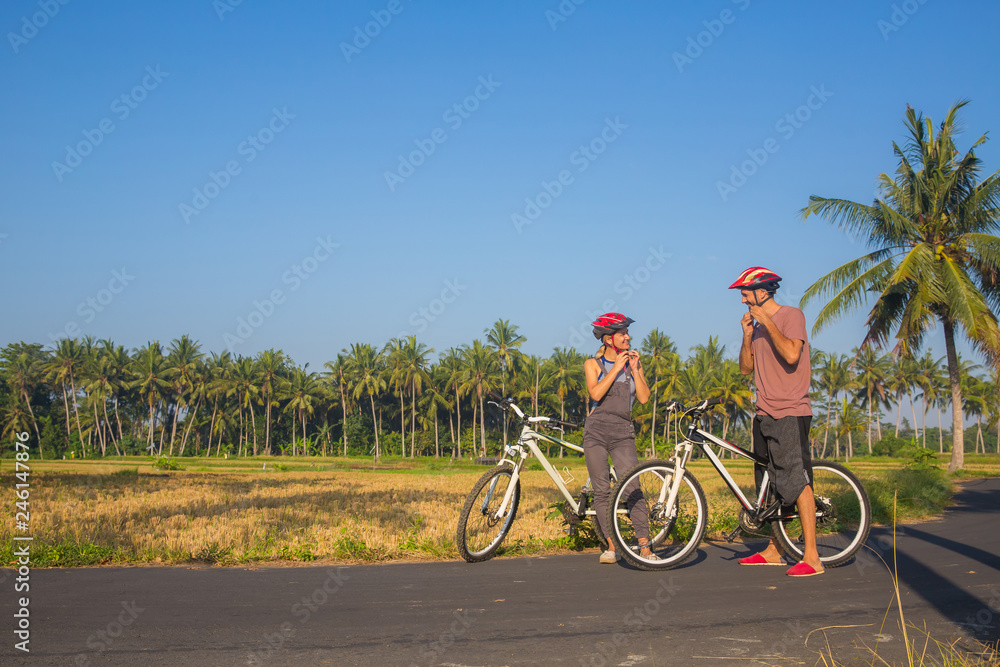 Obraz premium Bike helmet - cyclists putting biking helmets on outside during bicycle ride.