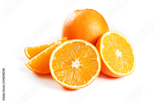 Close up image of juicy organic whole and halved oranges with visible core texture on isolated white background with a lot of copy space for text. Macro shot of bright citrus fruit slices. Top view.