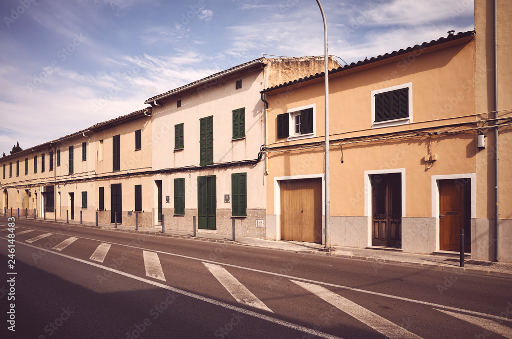 Retro stylized picture of a street in Alcudia at sunset, Mallorca, Spain.