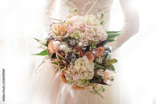 the bride holds a wedding bouquet
