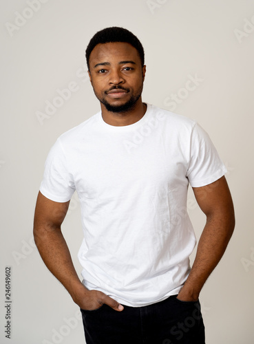 Half length portrait of handsome young man in neutral face and confident facial expressions