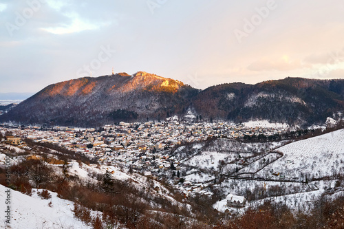 Brasov city covered in snow from top view at sunset