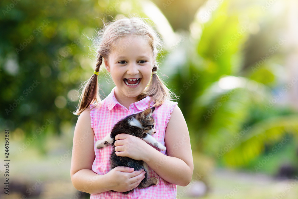 Little girl holding baby cat. Kids and pets Little girl holding baby cat. Kids and pets