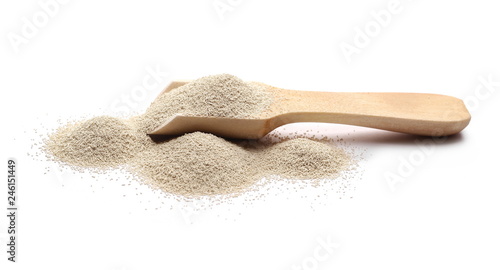 Dry yeast in wooden spoon isolated on white background 