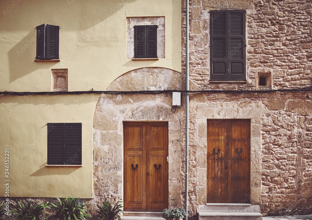 Retro stylized picture of an old building facade in Alcudia, Mallorca, Spain.