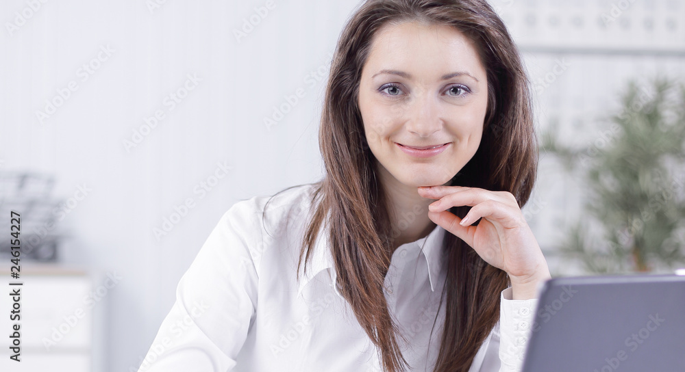 friendly female employee sitting at her Desk. friendly female employee sitting at her Desk.