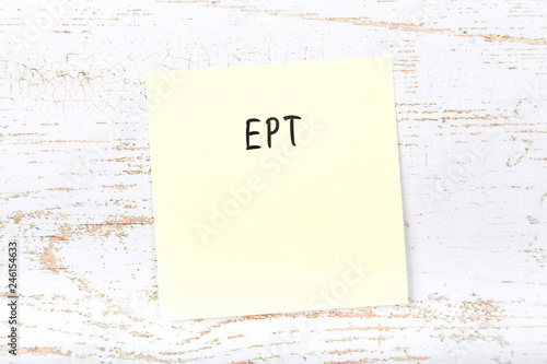 Yellow sticky note with handwritten text ept photo