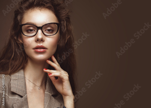 Beautiful girl in stylish clothes with glasses for vision and red sexy lips.