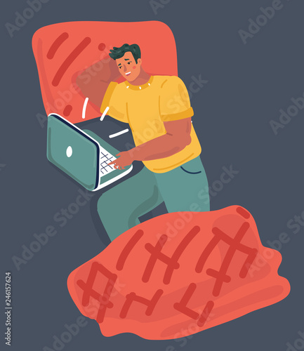 Young guy lying in the bed look at laptop.