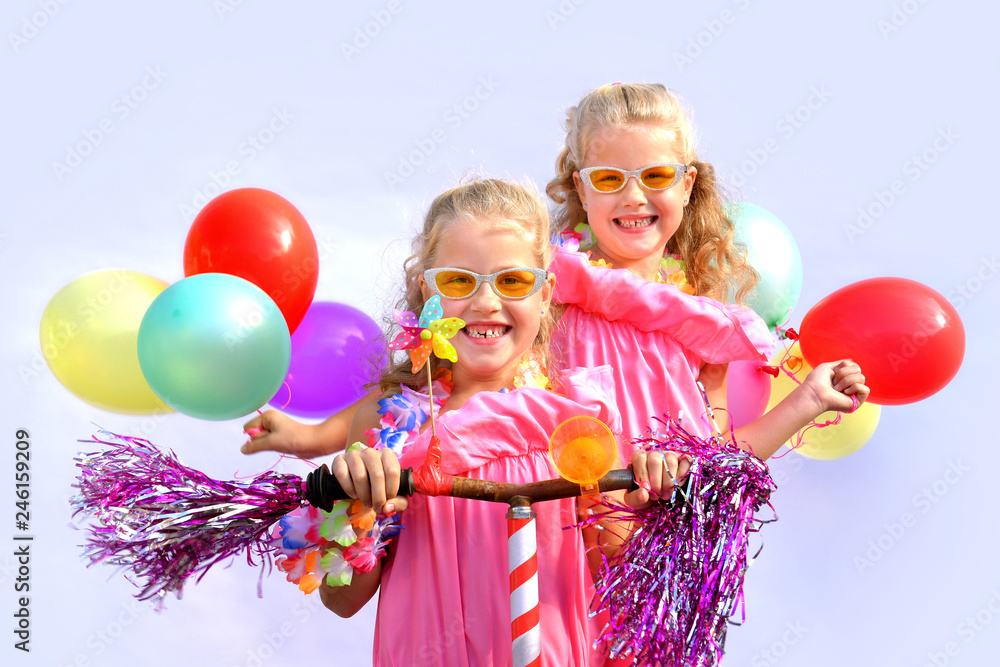 Twin sisters play together riding an imaginative bicycle. They use a rusty handlebar they found in the garage. They fit it with fringes, a windmill and an orange plastic horn. Twin sisters play together riding an imaginative bicycle. They use a rusty handlebar they found in the garage. They fit it with fringes, a windmill and an orange plastic horn.