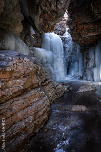 Frozen waterfall in a mountain gorge