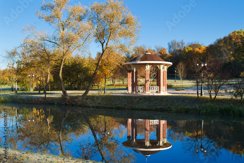 Sunny morning in the park. Reflection in the lake. Loshitsky park. Minsk. Belarus. photo