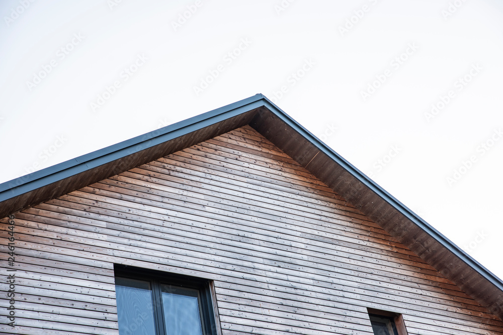 new house with wooden facade and new roof