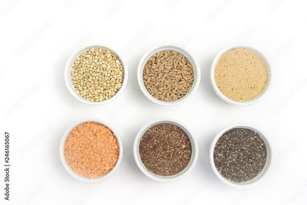 Collection of different groats on white background. Top view of buckwheat, chia, flax, amaranth, lentils, couscous, wheat Collection of different groats on white background. Top view of buckwheat, chia, flax, amaranth, lentils, couscous, wheat