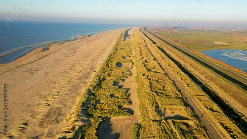 People walking on the beatch - Dutch coastline Hondsbossche seawall photo