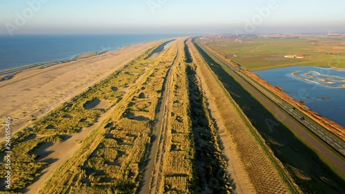 People walking on the beatch - Dutch coastline Hondsbossche seawall photo