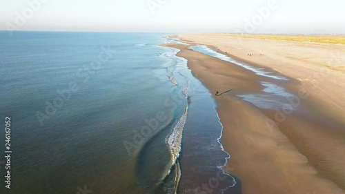 People walking on the beatch - Dutch coastline Hondsbossche seawall photo