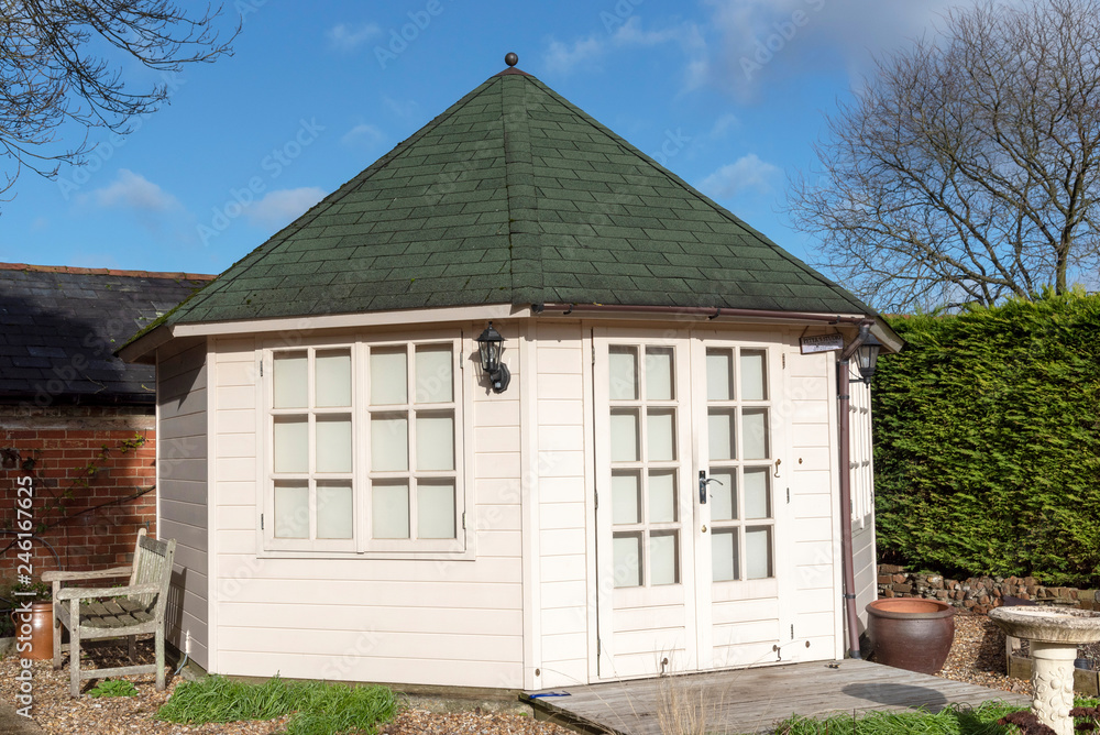 A pine constructed garden office with decking area and landscaped garden, viewed in winter. Situated in Southern England UK A pine constructed garden office with decking area and landscaped garden, viewed in winter. Situated in Southern England UK