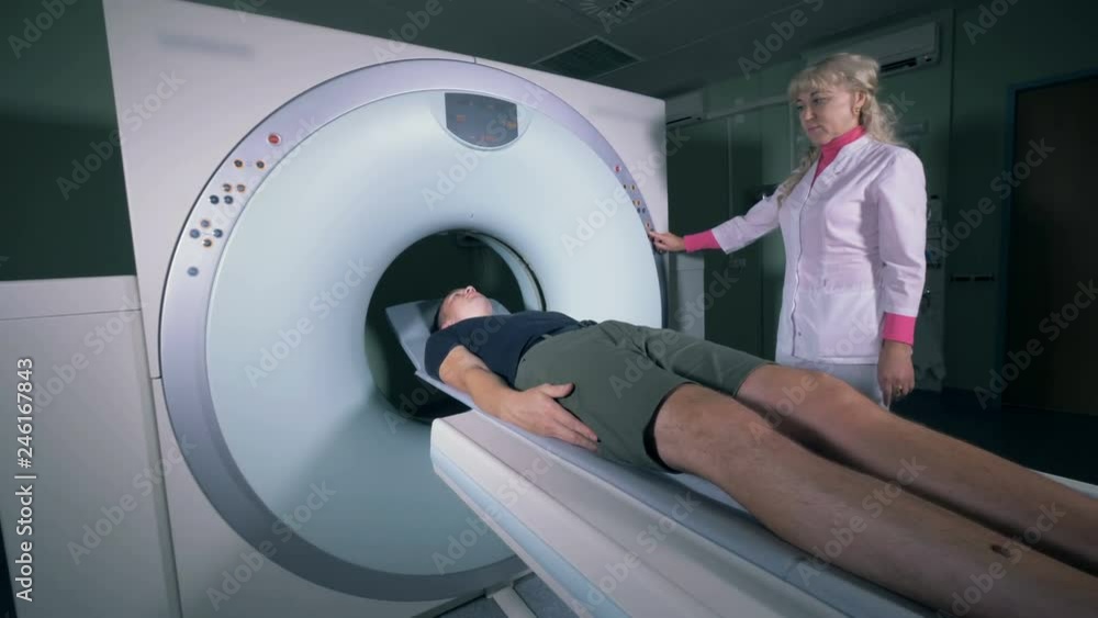 Tomographic scanning on a patient, close up. Tomographic scanning on a patient, close up.