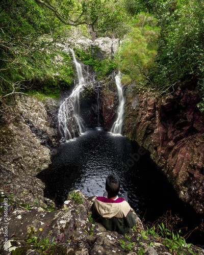 Boy watching waterfall in Reunion Island