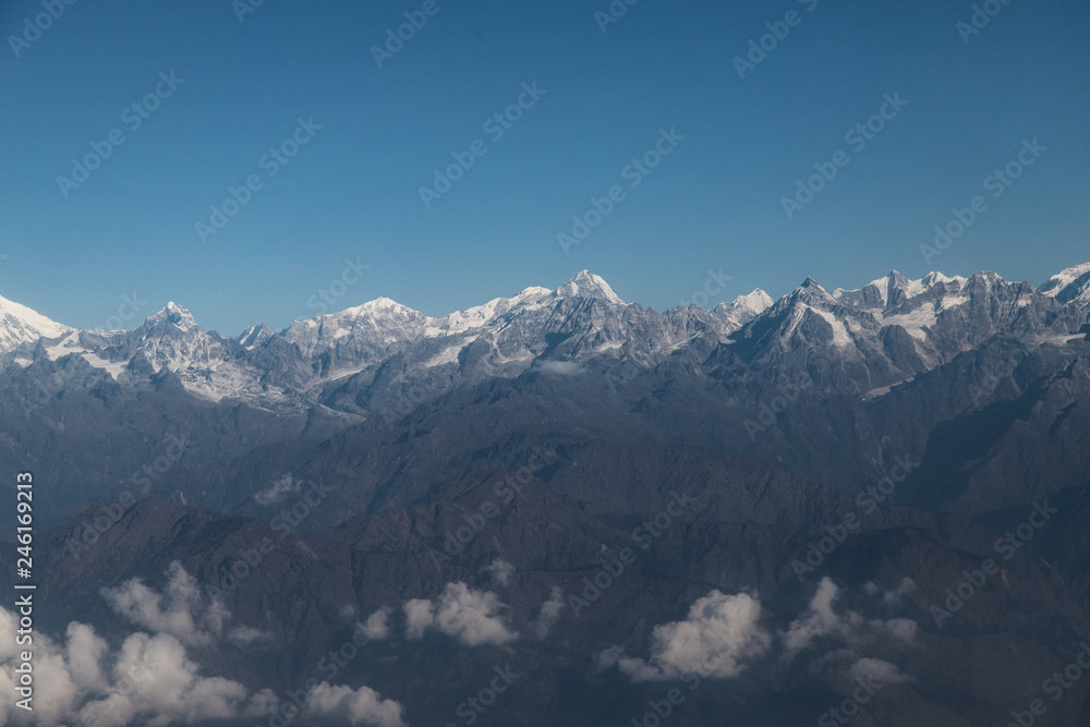 Himalayan mountain range view with snow capped peaks.