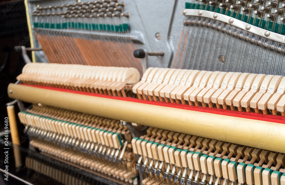 Close-up view of hammers and strings inside the piano. Close-up view of hammers and strings inside the piano.