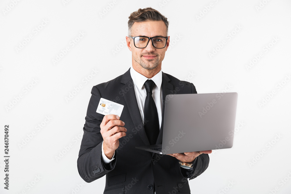 Handsome business man isolated over white wall background using laptop computer. Handsome business man isolated over white wall background using laptop computer.