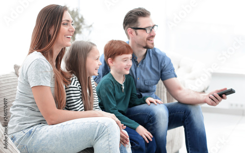 family watches TV in the modern living room