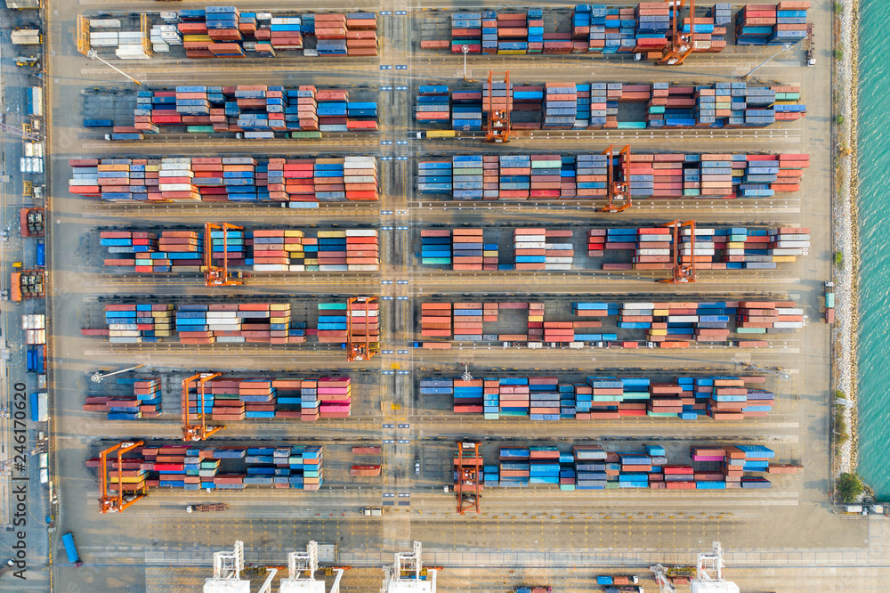 Aerial view. Container ship in pier with crane bridge carries out export and import business in the sea.