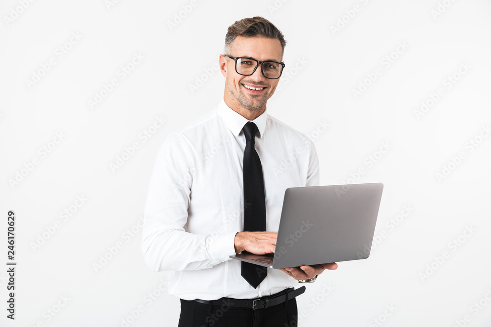 Handsome business man isolated over white wall background using laptop computer.