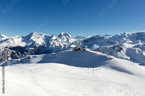 Slope on the skiing resort in Alps, France. Sunny winter day. Winter vacation