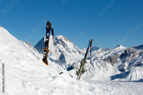 Ski equipment with panoramic view of winter mountains on a clear sunny winter day