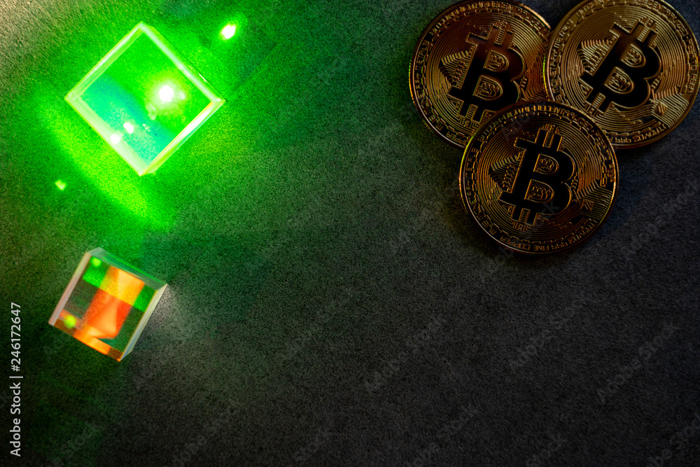 bitcoins and prisms with green laser glow