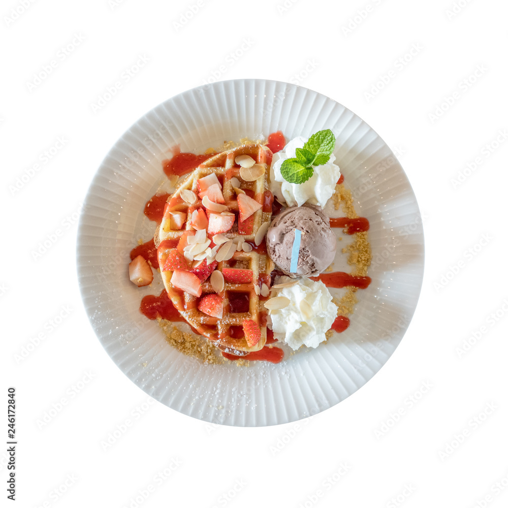 Top view of whole wheat Belgium waffle topped with strawberry syrup , whipped cream , walnuts and chocolate ice cream isolated on white background Top view of whole wheat Belgium waffle topped with strawberry syrup , whipped cream , walnuts and chocolate ice cream isolated on white background